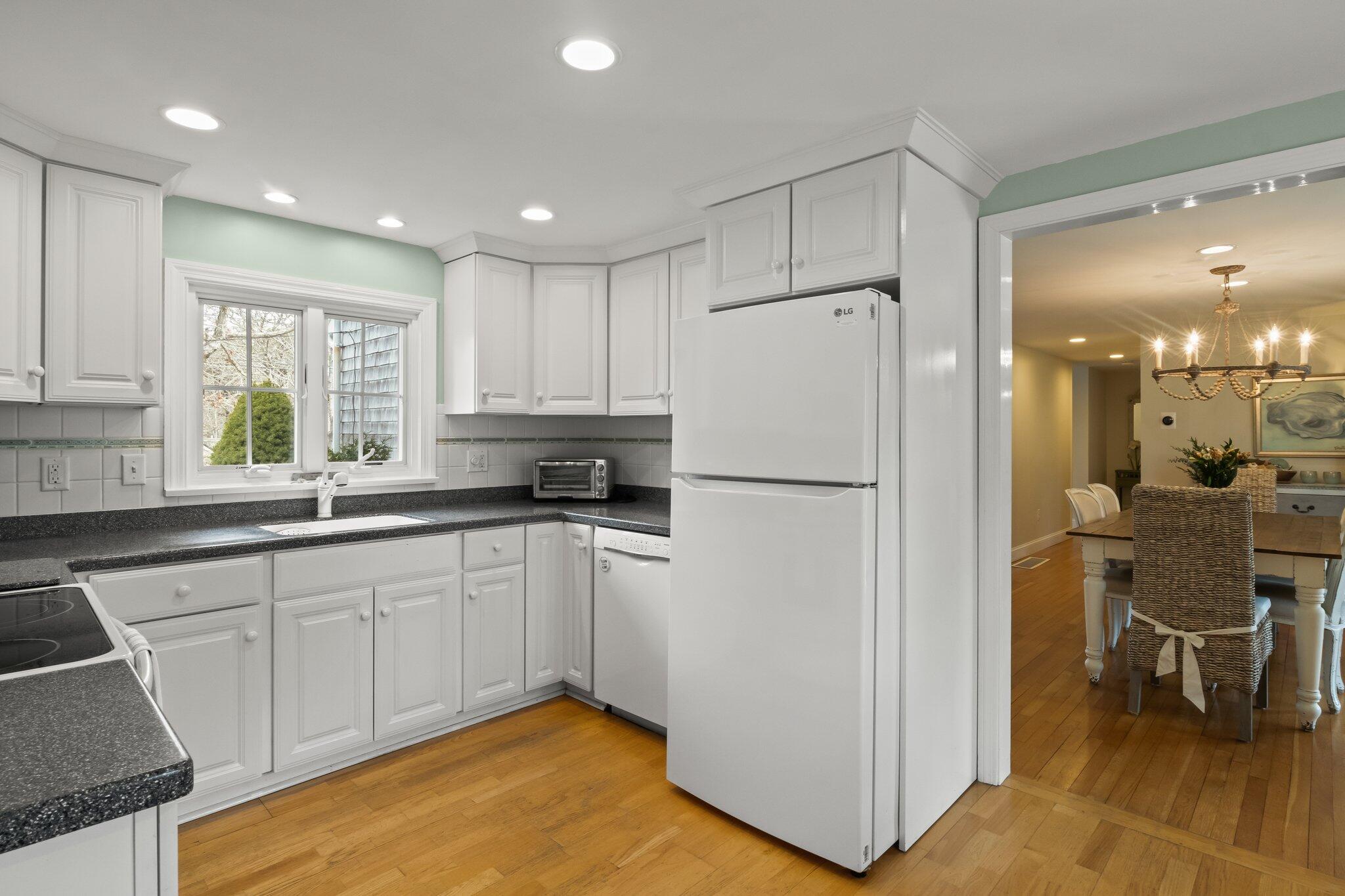 29 Jesse Eldredge Road Harwich, MA 02645 - Photo 28 of 56 a kitchen with white cabinets and white appliances