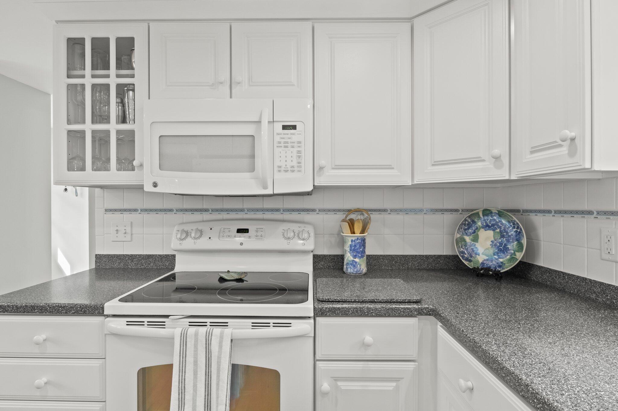 29 Jesse Eldredge Road Harwich, MA 02645 - Photo 30 of 56 a kitchen with granite countertop white cabinets and a stove