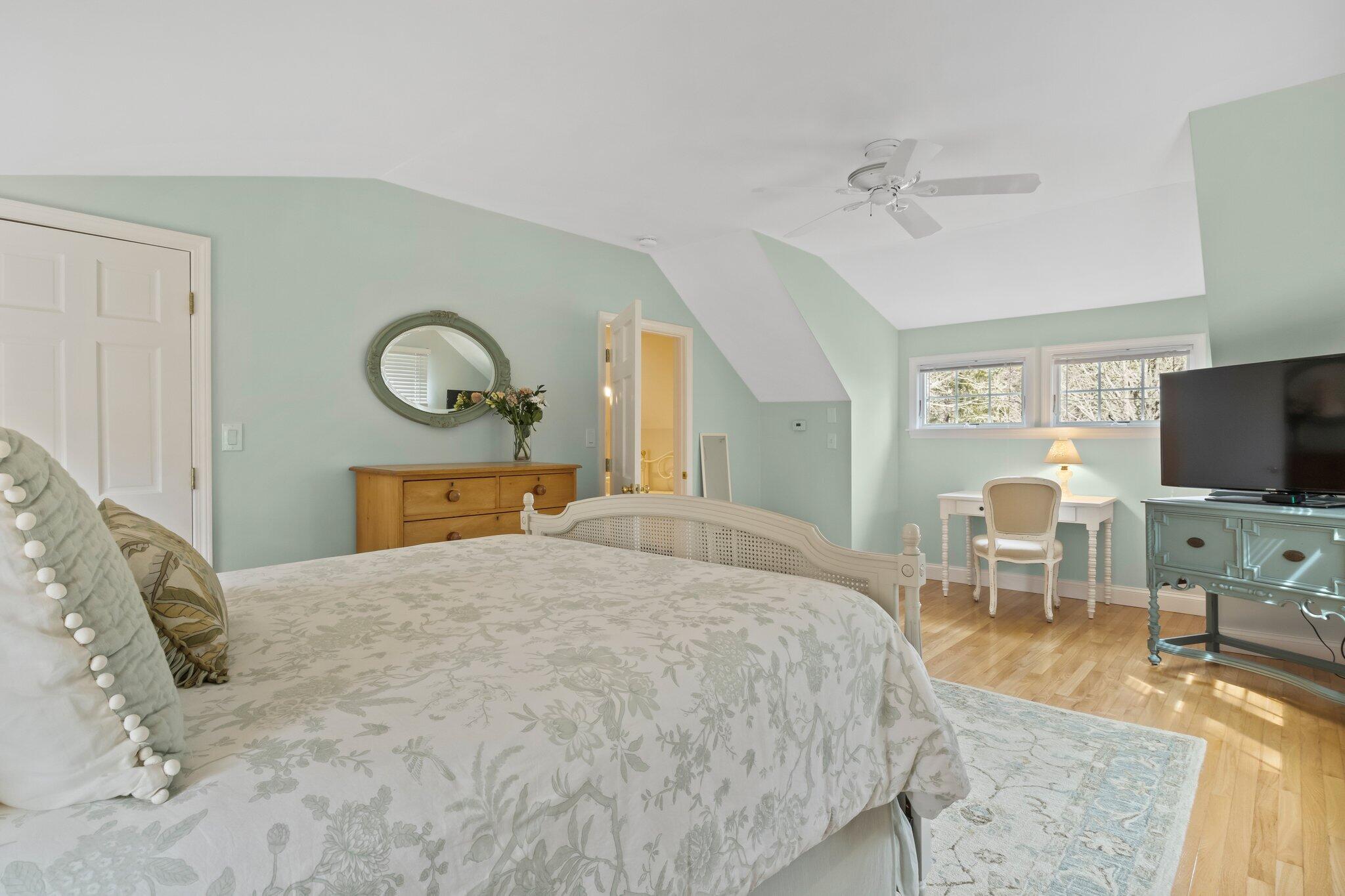 29 Jesse Eldredge Road Harwich, MA 02645 - Photo 39 of 56 a bedroom with a bed a table and chair with the view of mirror