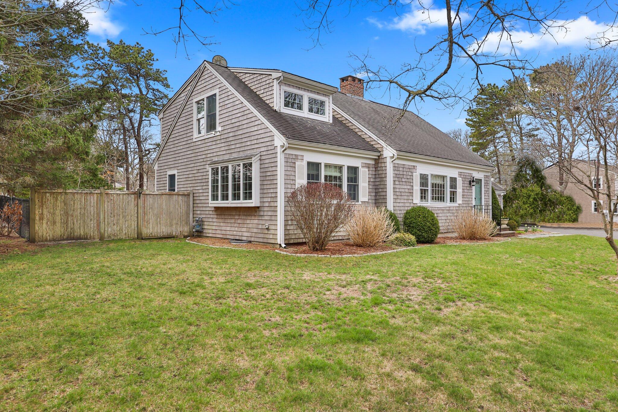 29 Jesse Eldredge Road Harwich, MA 02645 - Photo 4 of 56 a front view of a house with a garden