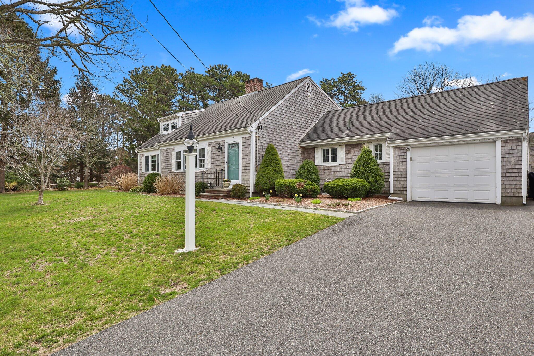 29 Jesse Eldredge Road Harwich, MA 02645 - Photo 5 of 56 front view of house with a yard