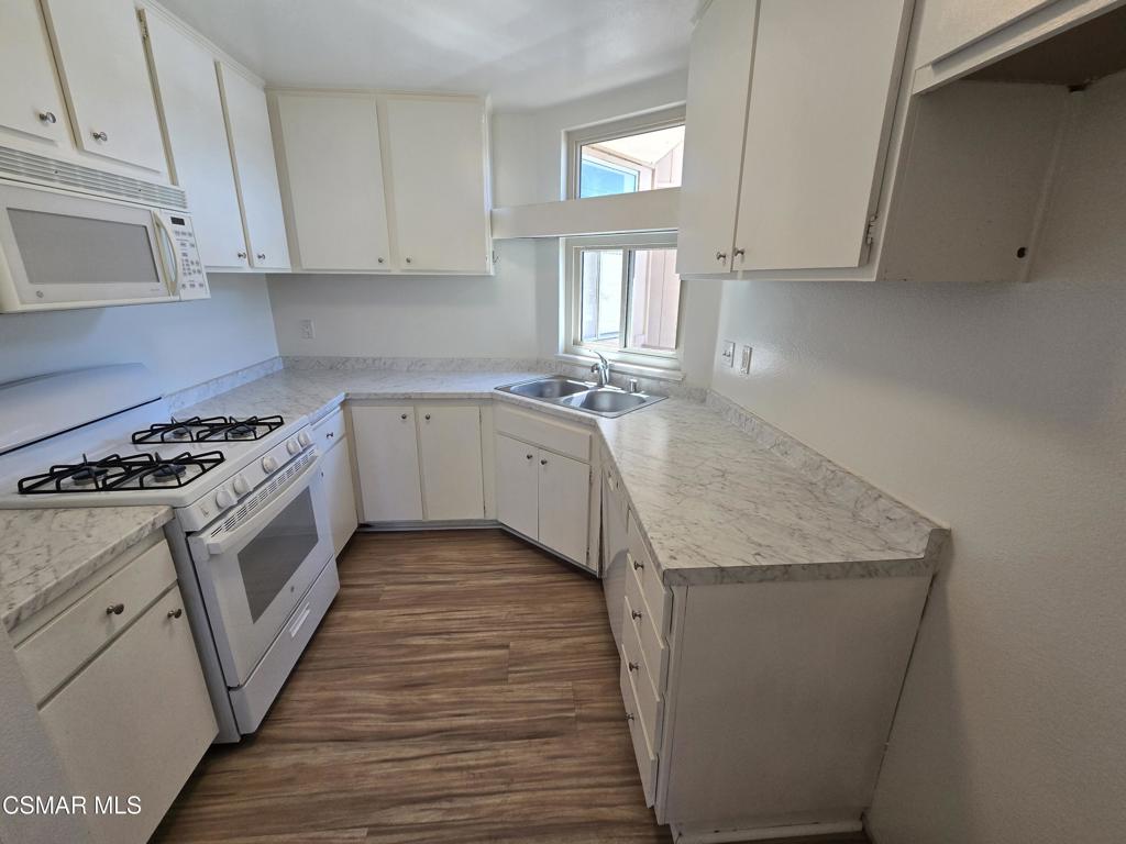 1778 Sinaloa Road, Unit 294 Simi Valley, CA 93065 - Photo 2 of 13 a kitchen with granite countertop a sink stove and cabinets