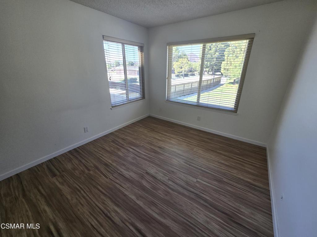 1778 Sinaloa Road, Unit 294 Simi Valley, CA 93065 - Photo 5 of 13 a view of an empty room with wooden floor and a window