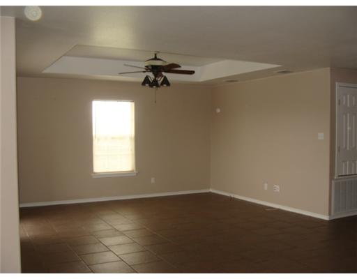 1214 Jonnell Street Corpus Christi, TX 78418 - Photo 3 of 10 an empty room with a window and a ceiling fan