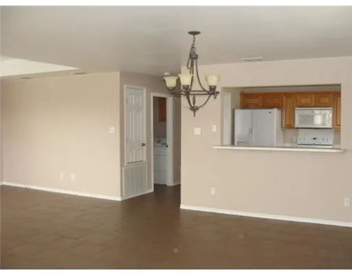 a view of a livingroom with wooden floor and a ceiling fan