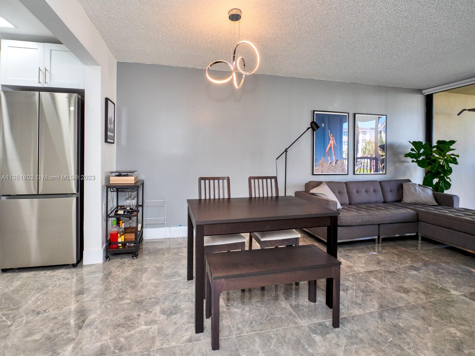 10865 Southwest 112th Avenue, Unit 209 Miami, FL 33176 - Photo 12 of 29 a living room with furniture a refrigerator and a couch