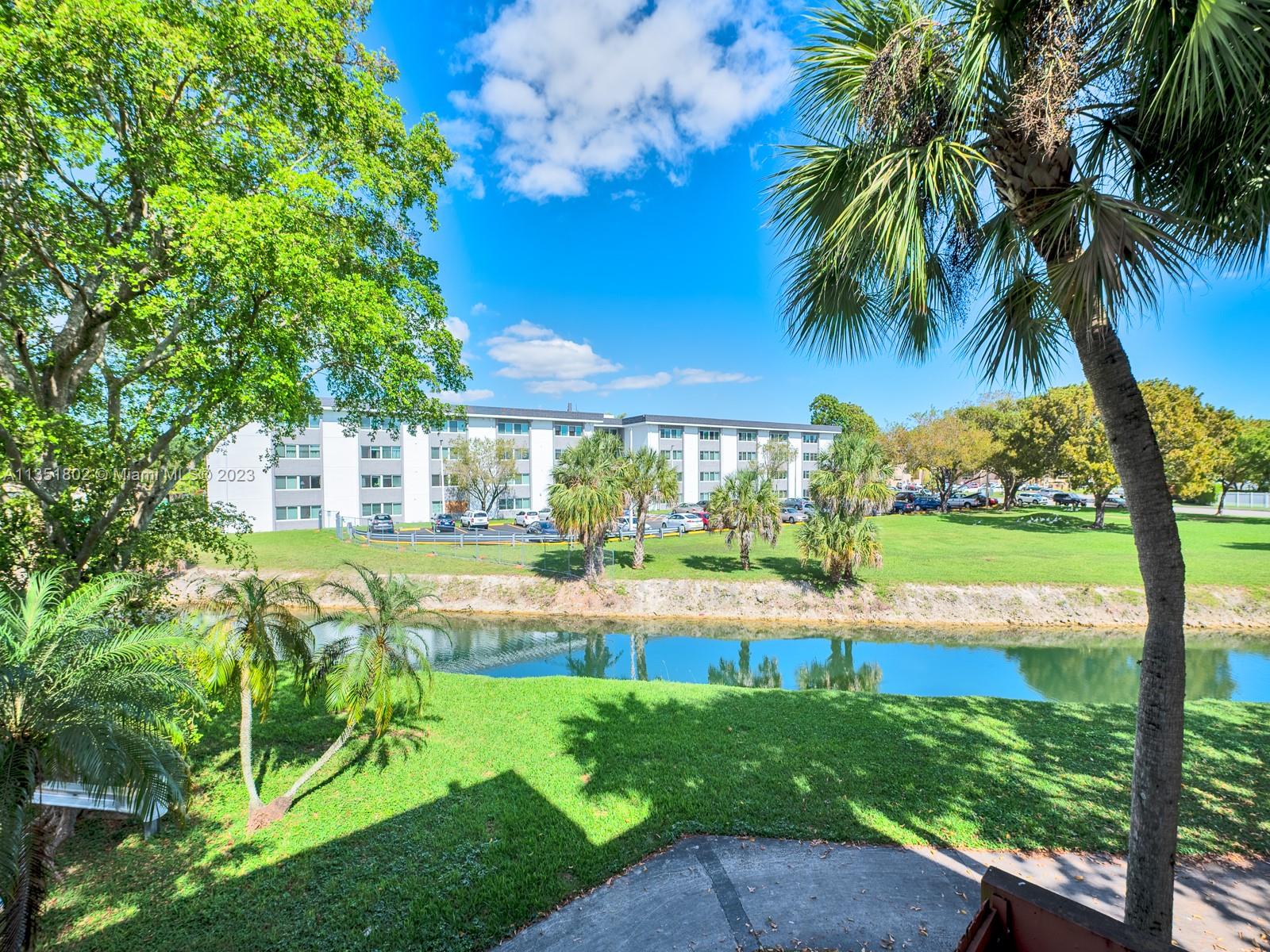 10865 Southwest 112th Avenue, Unit 209 Miami, FL 33176 - Photo 16 of 29 a view of a swimming pool with a garden