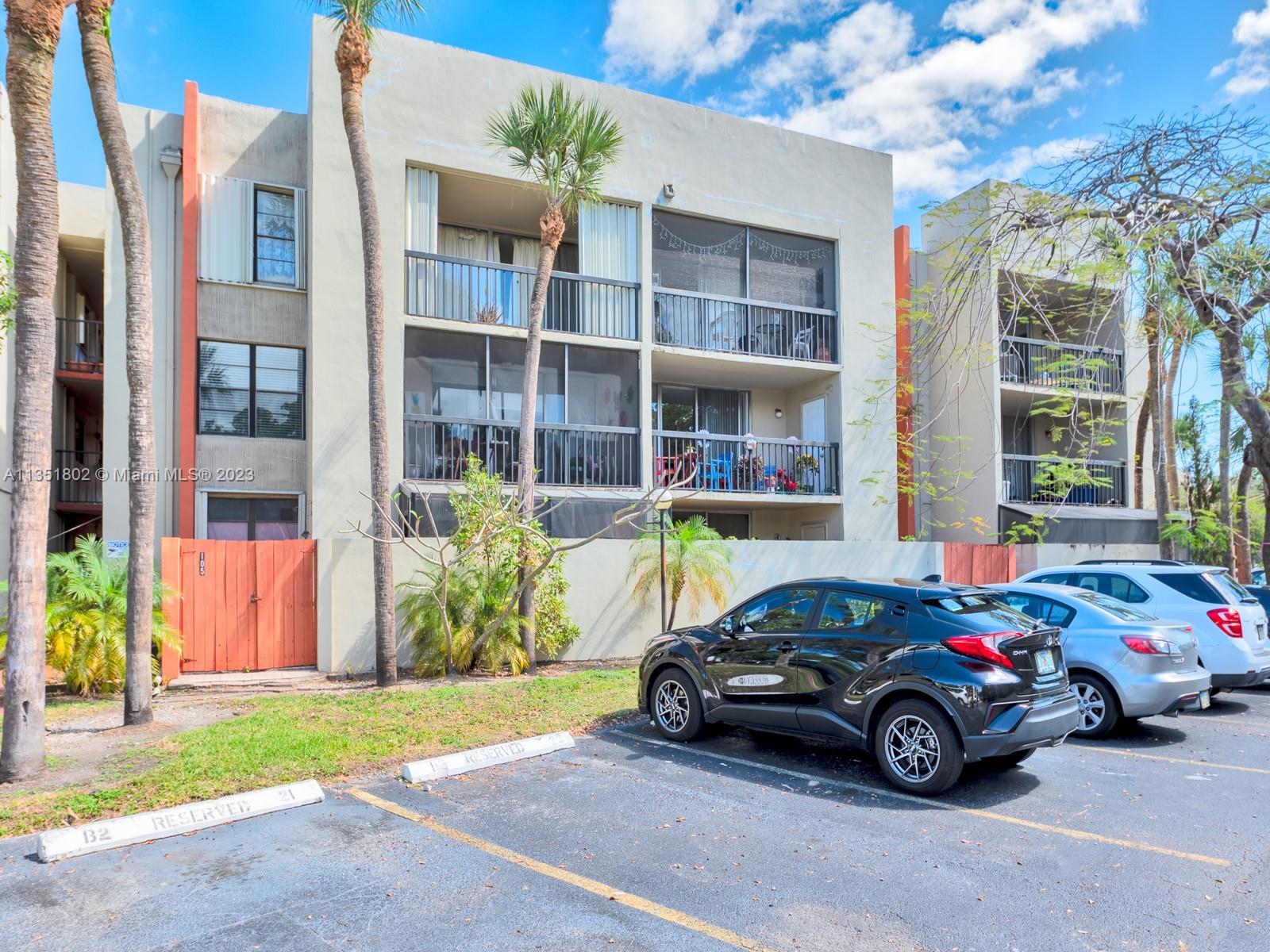 10865 Southwest 112th Avenue, Unit 209 Miami, FL 33176 - Photo 2 of 29 a car parked in front of a brick building