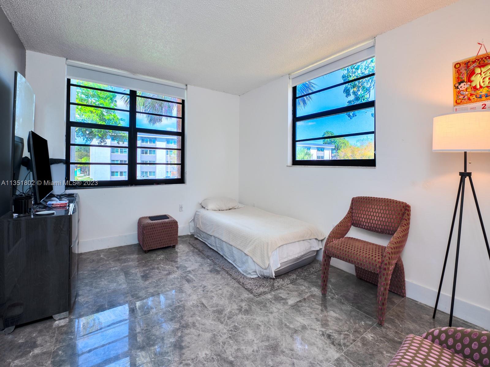 10865 Southwest 112th Avenue, Unit 209 Miami, FL 33176 - Photo 21 of 29 a living room with furniture and a window