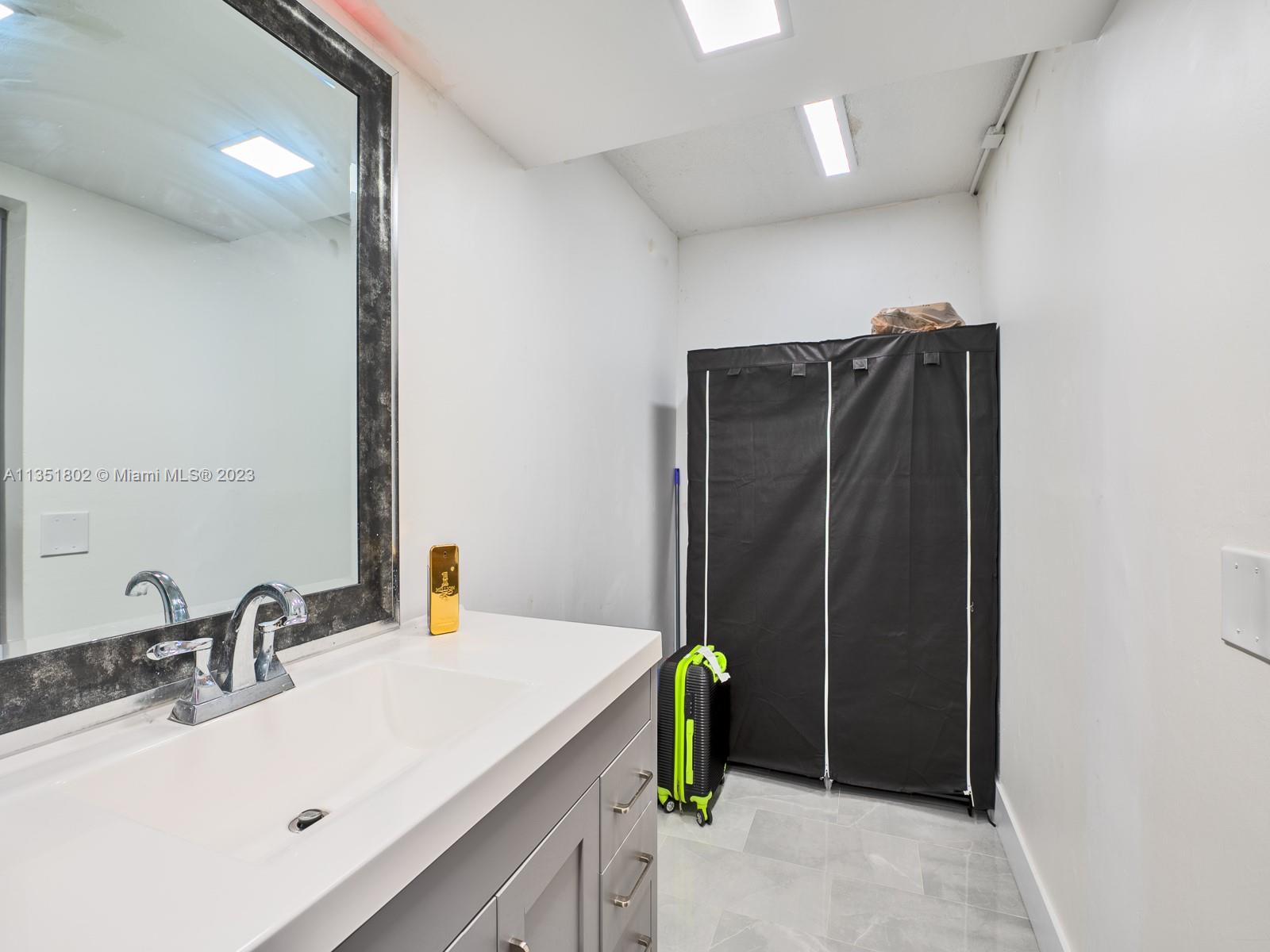 10865 Southwest 112th Avenue, Unit 209 Miami, FL 33176 - Photo 24 of 29 a bathroom with a sink and a mirror