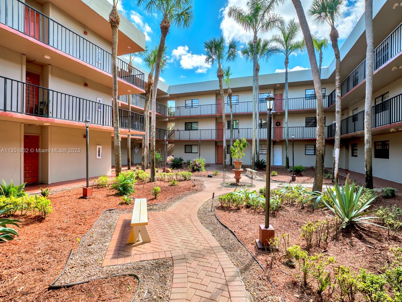 10865 Southwest 112th Avenue, Unit 209 Miami, FL 33176 - Photo 3 of 29 a view of a building with a patio