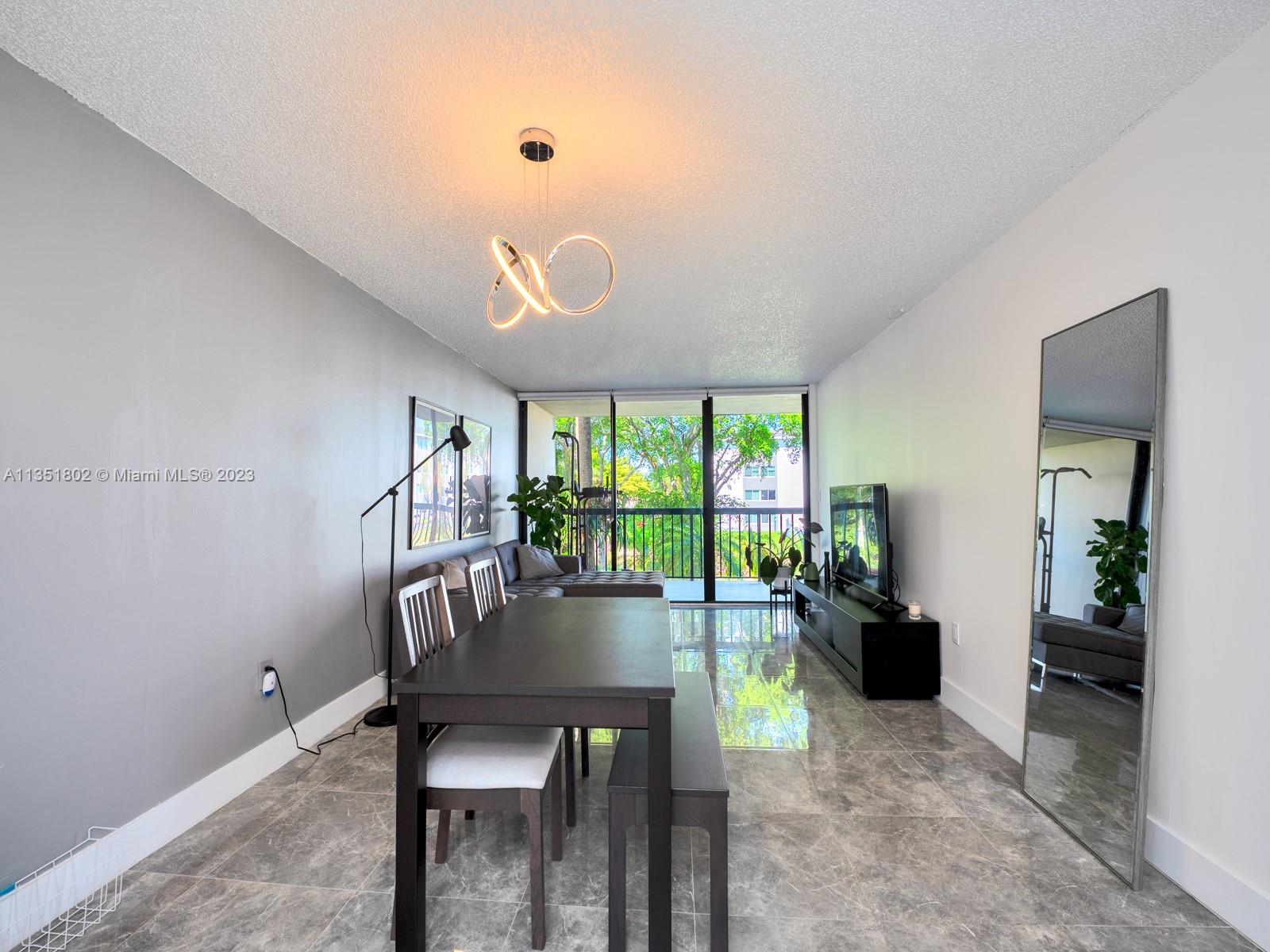 10865 Southwest 112th Avenue, Unit 209 Miami, FL 33176 - Photo 7 of 29 a dining room with furniture and a floor to ceiling window
