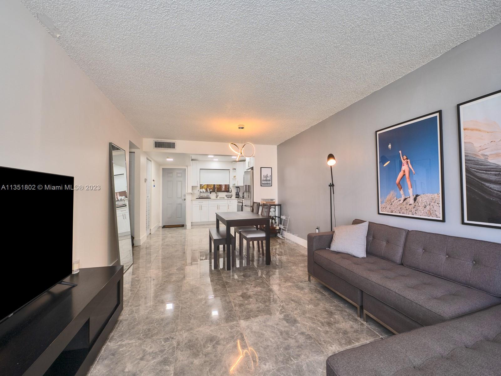 10865 Southwest 112th Avenue, Unit 209 Miami, FL 33176 - Photo 8 of 29 a living room with furniture and a flat screen tv