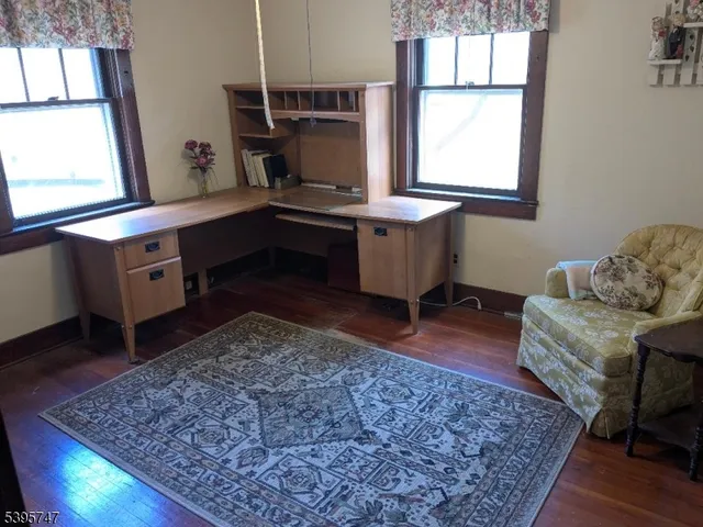 a living room with furniture rug and a table