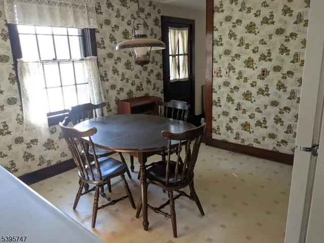 a view of a dining room with furniture and a window