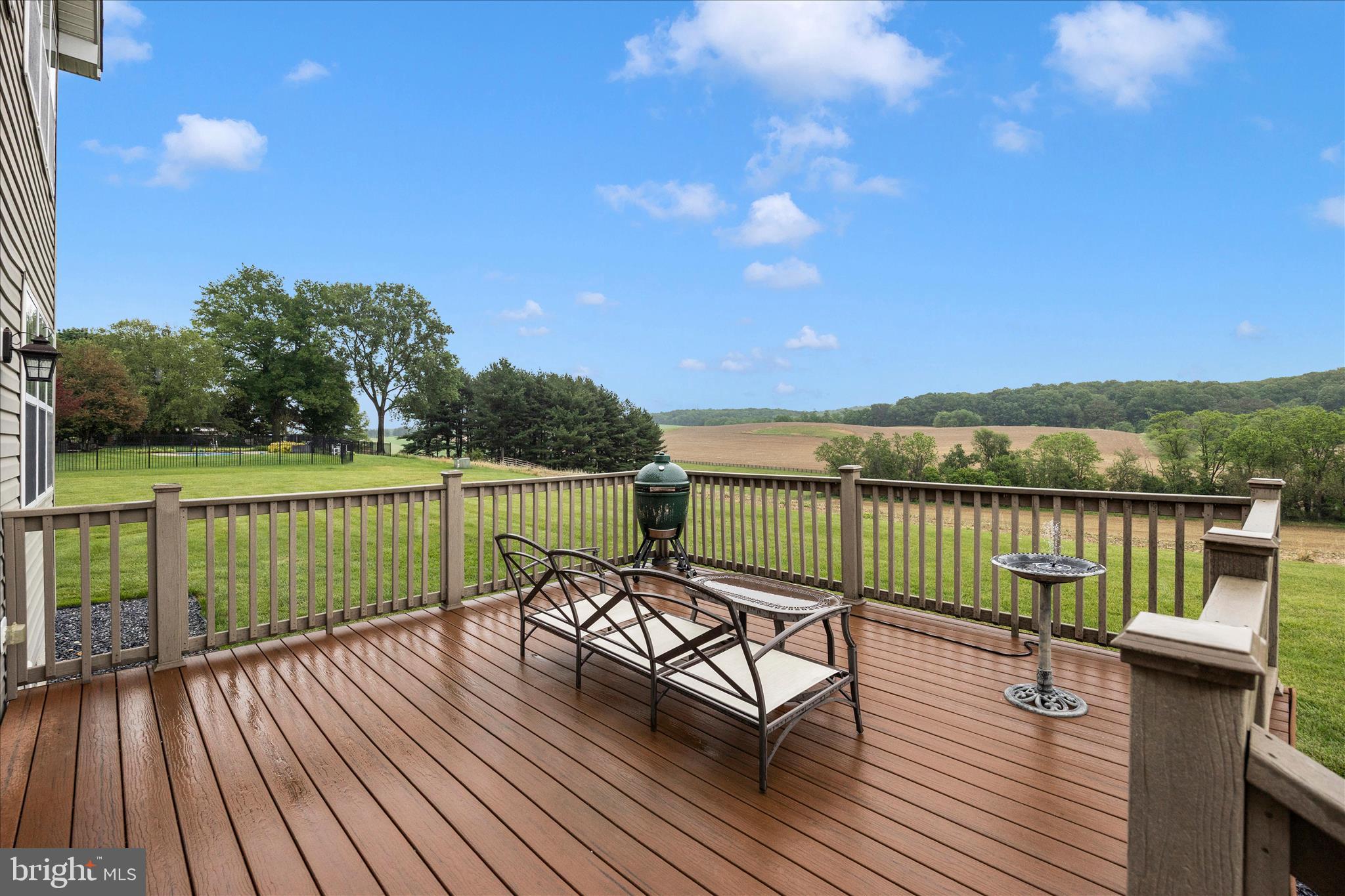 9855 McKinstry Mill Road New Windsor, MD 21776 - Photo 47 of 76 a view of a deck with wooden floor and lake view