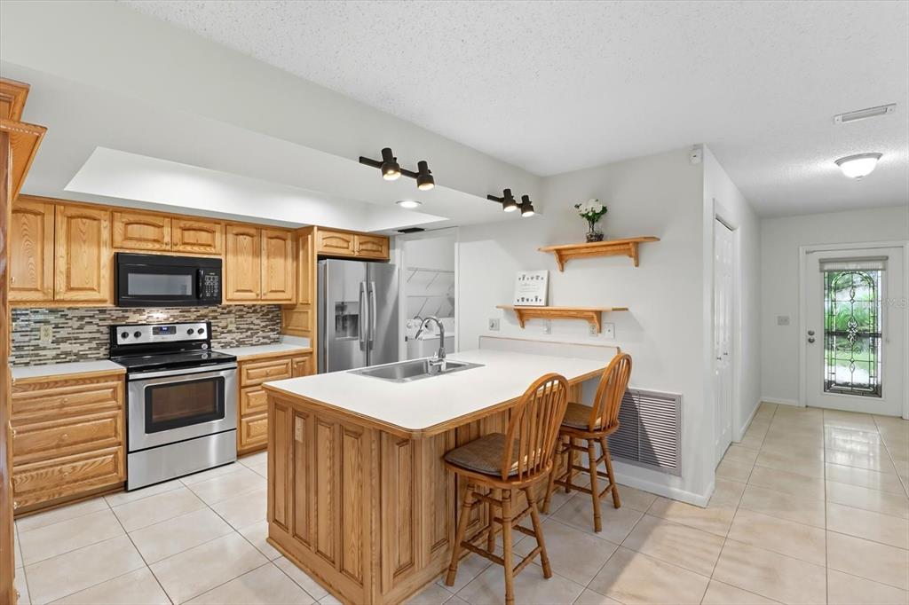 25 Jamaica Street Homosassa, FL 34446 - Photo 11 of 49 a kitchen with stainless steel appliances kitchen island granite countertop a sink and cabinets