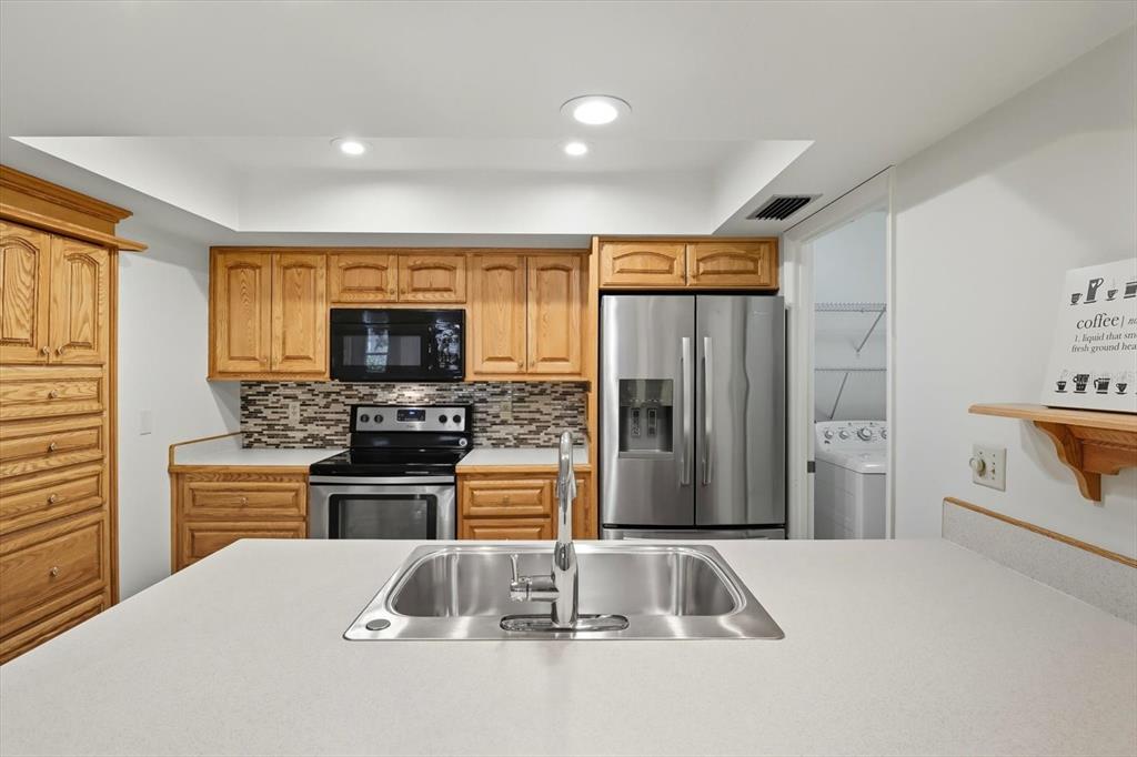 25 Jamaica Street Homosassa, FL 34446 - Photo 12 of 49 a kitchen with stainless steel appliances granite countertop a refrigerator stove and sink