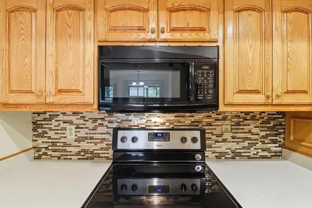 a stove top oven sitting inside of a kitchen