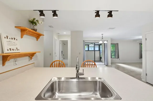a kitchen with a sink and a refrigerator with a faucet