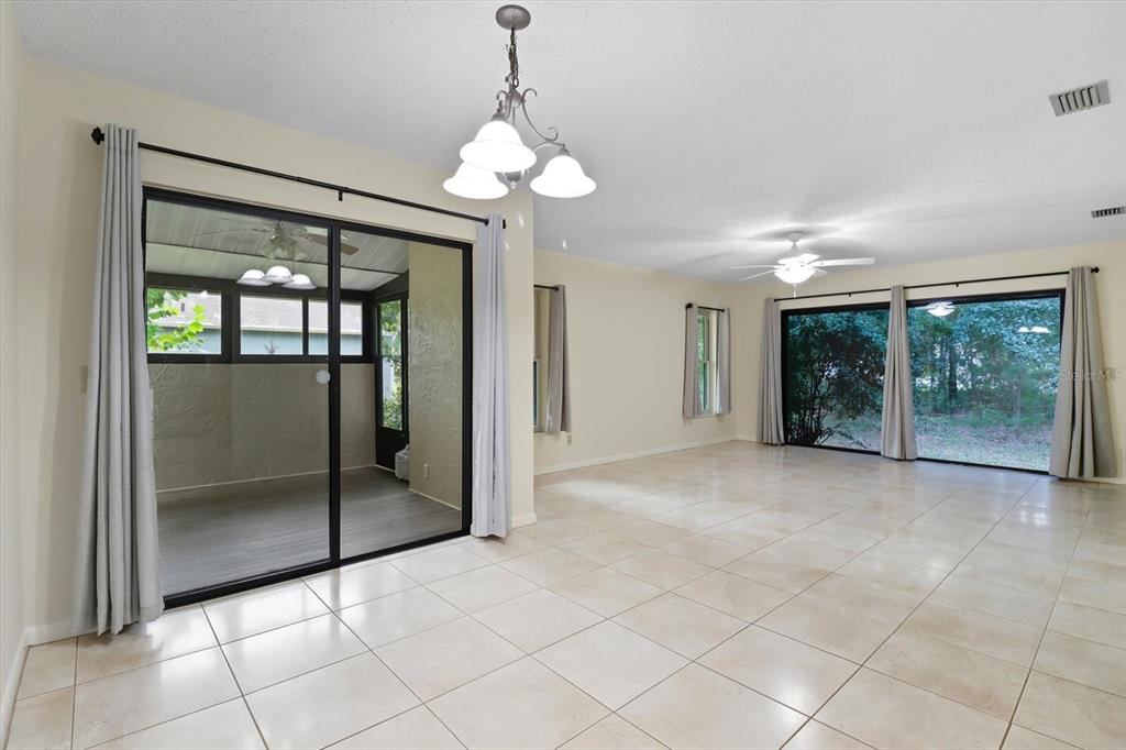 25 Jamaica Street Homosassa, FL 34446 - Photo 19 of 49 a view of an empty room with sliding glass door and chandelier