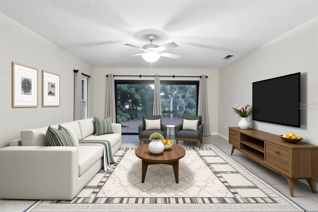 25 Jamaica Street Homosassa, FL 34446 - Photo 20 of 49 a living room with furniture and a flat screen tv