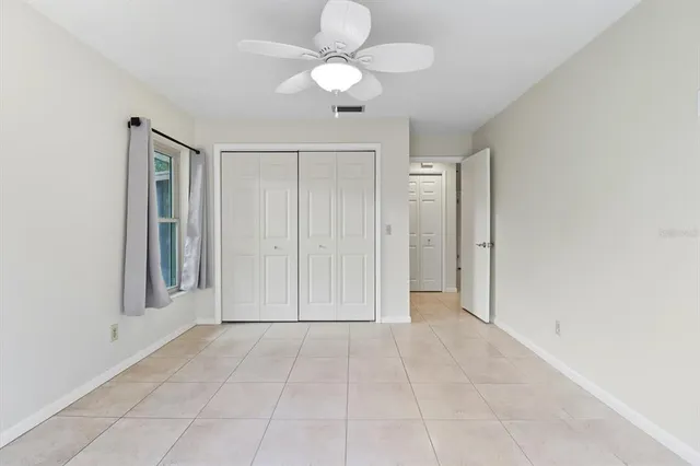 a view of an empty room with a fan