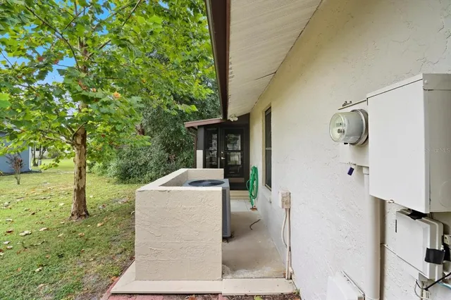 a backyard of a house with table and chairs