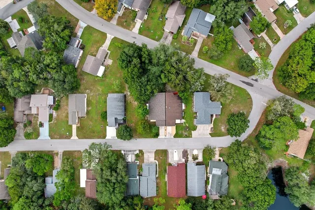 an aerial view of residential houses with outdoor space