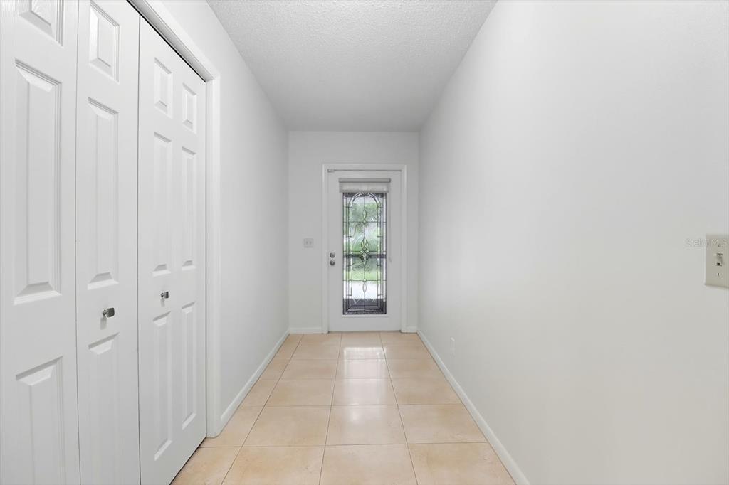 25 Jamaica Street Homosassa, FL 34446 - Photo 8 of 49 a view of a hallway with white walls and a window
