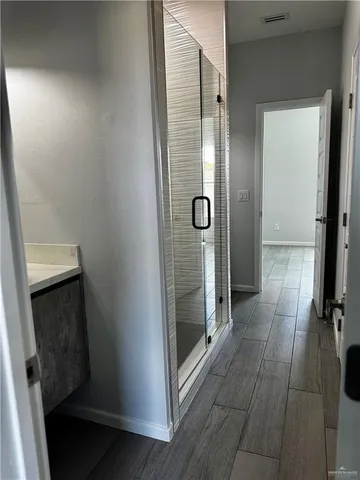 a bathroom with a glass door shower