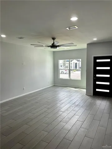 an empty room with windows and closet