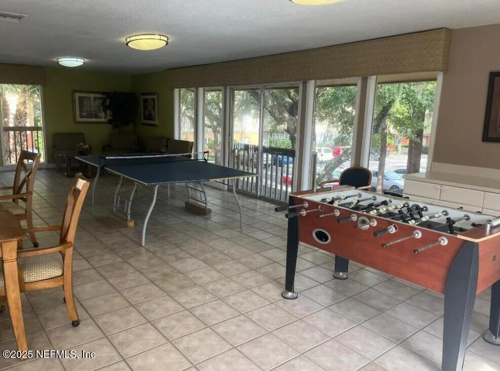 1800 Park Avenue, Unit 339 Orange Park, FL 32073 - Photo 12 of 14 a living room with furniture a rug and a floor to ceiling window