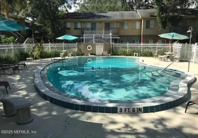 a view of a swimming pool with a patio
