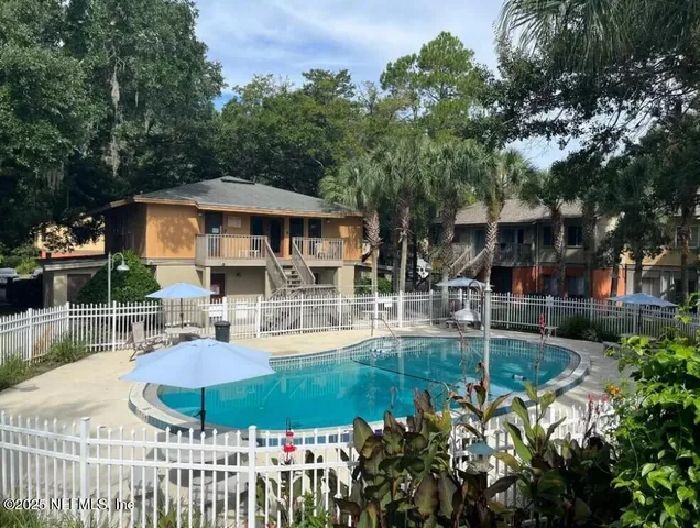 a view of a house with backyard and sitting area