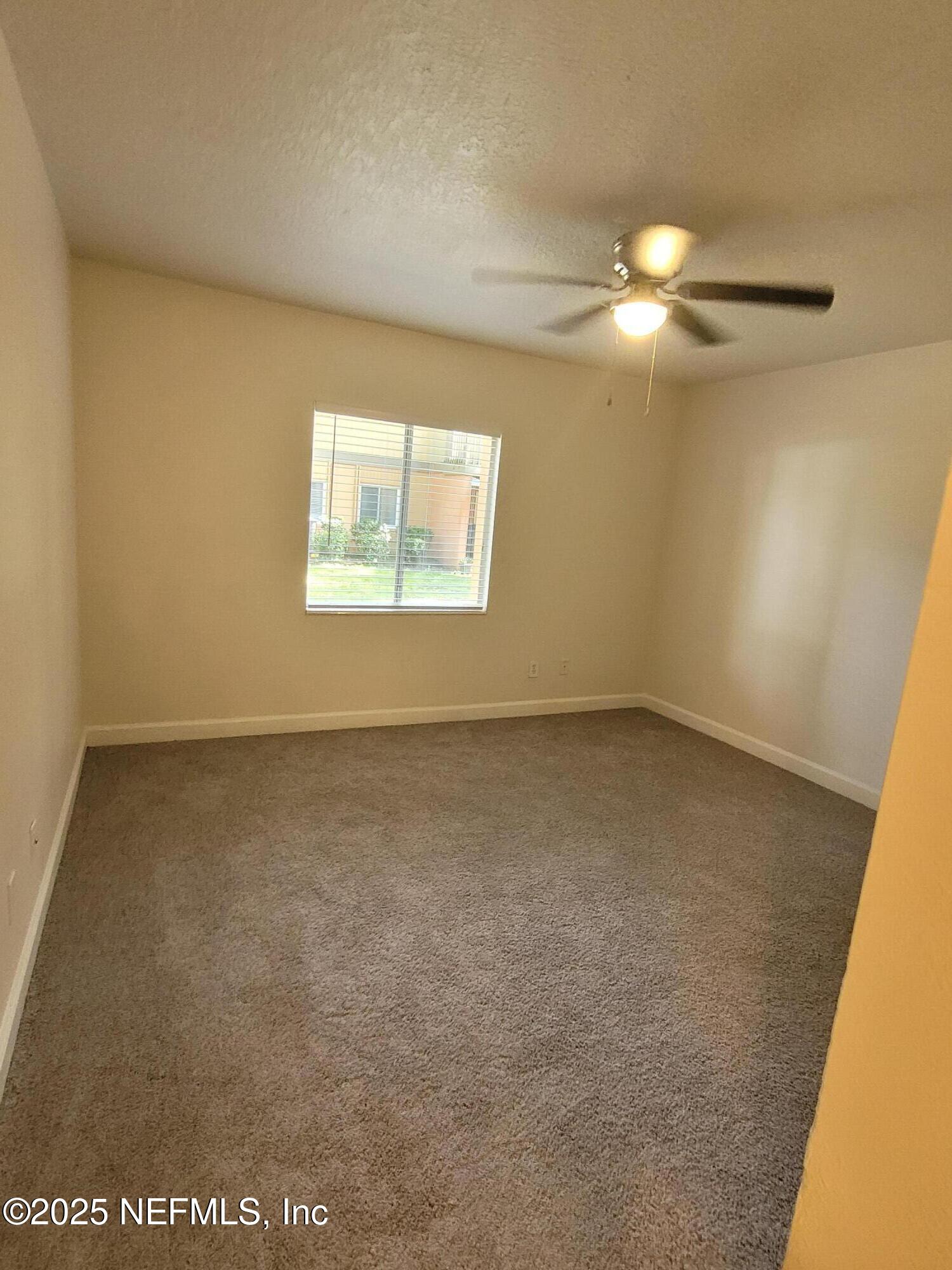 1800 Park Avenue, Unit 339 Orange Park, FL 32073 - Photo 6 of 14 an empty room with a empty space and a window