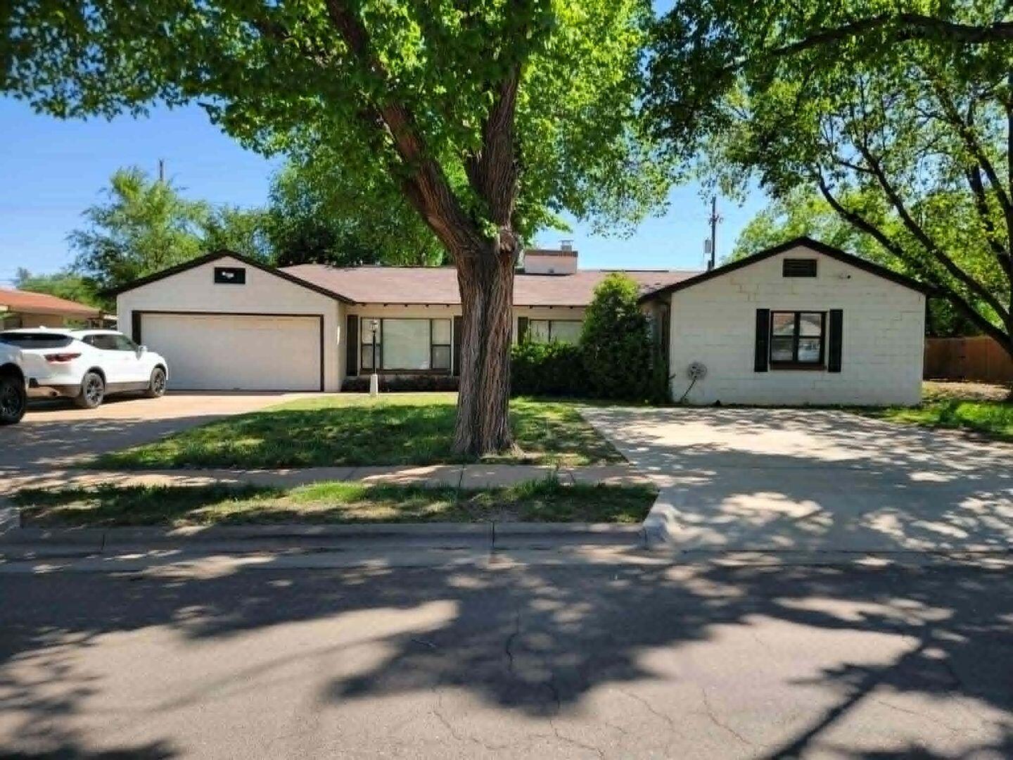 3105 29th Street Lubbock, TX 79410 - Photo 1 of 18 a front view of a house with a yard
