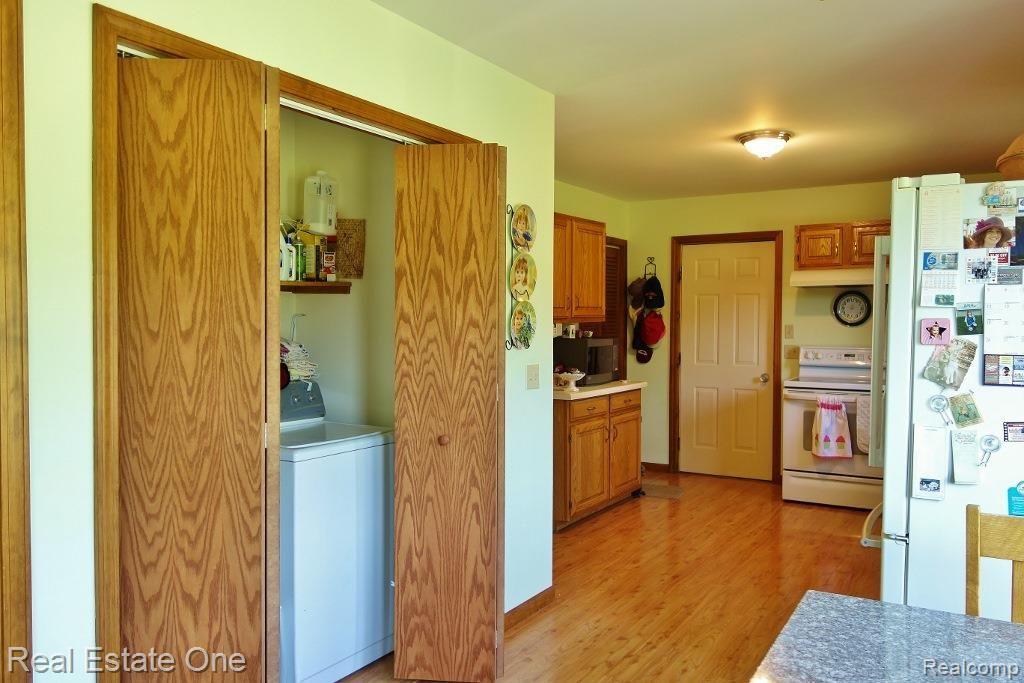 1405 Parker Road Holly, MI 48442 - Photo 12 of 51 First floor laundry center. Washer and dryer stay