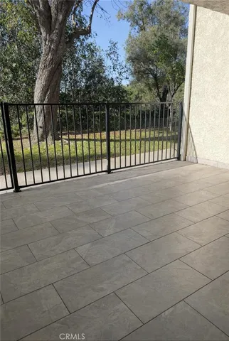 a kitchen with kitchen island granite countertop a stove refrigerator and cabinets