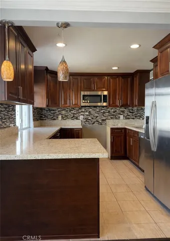 a view of a livingroom with wooden floor and a fireplace