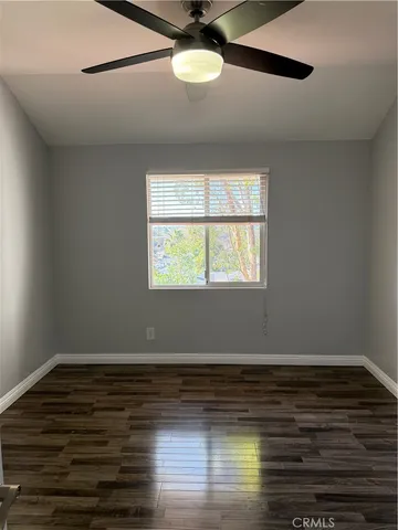 a view of a room with wooden floor and a window