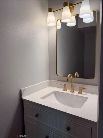 an empty room with wooden floor fireplace and windows