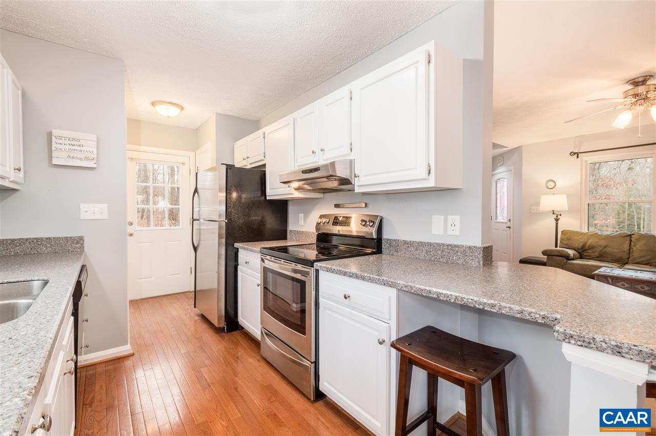 33 Oak Grove Road Palmyra, VA 22963 - Photo 12 of 42 a kitchen with stainless steel appliances granite countertop a stove a sink and a refrigerator