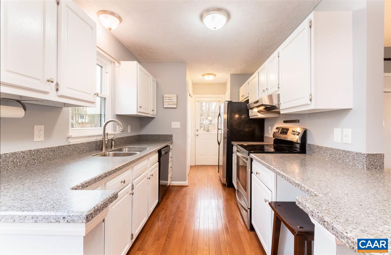 33 Oak Grove Road Palmyra, VA 22963 - Photo 13 of 42 a kitchen with granite countertop a sink a counter top space stainless steel appliances and cabinets