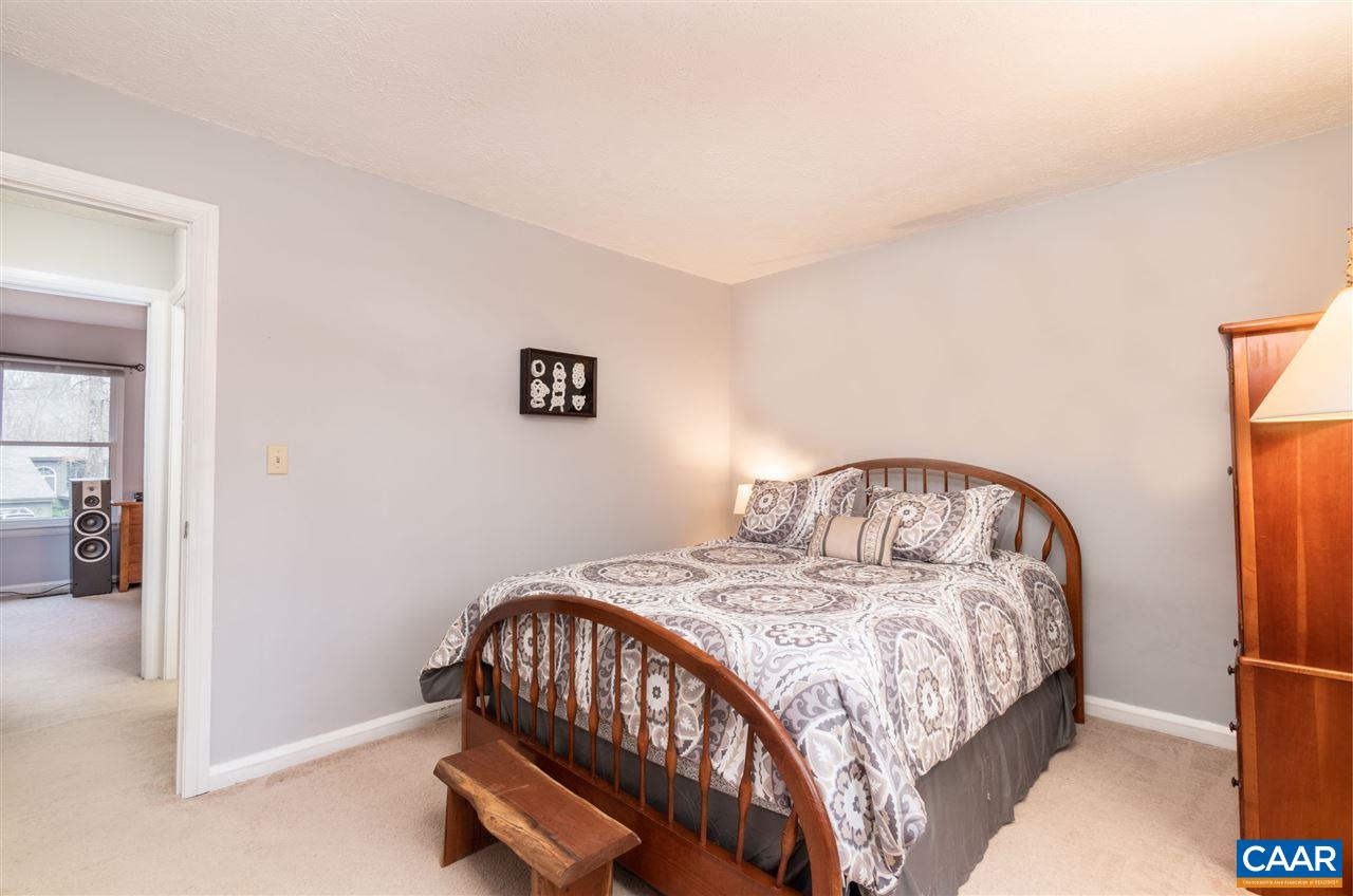 33 Oak Grove Road Palmyra, VA 22963 - Photo 18 of 42 a bedroom with a bed and a table in it