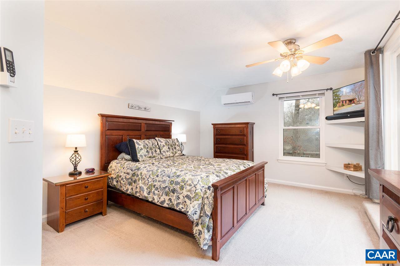 33 Oak Grove Road Palmyra, VA 22963 - Photo 27 of 42 a bedroom with a bed and a chandelier