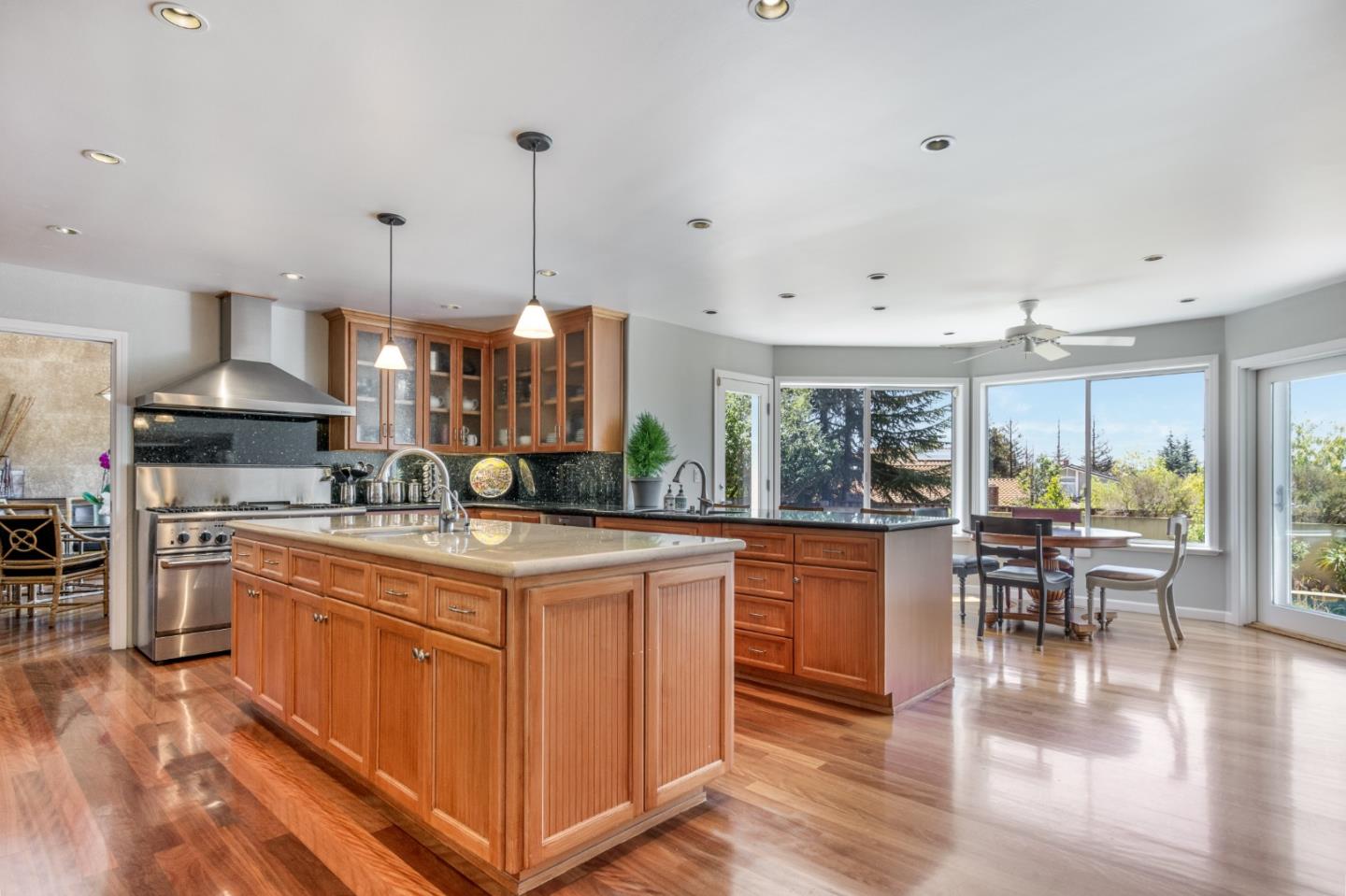 a kitchen with stainless steel appliances granite countertop a stove and more cabinets