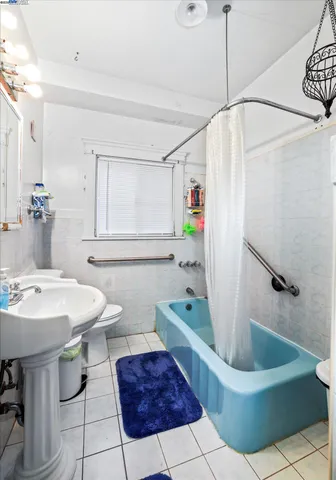 a bathroom with a sink a toilet and bathtub
