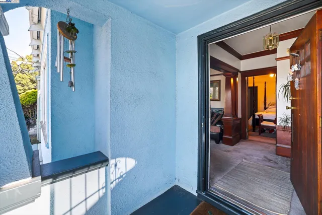 a view of a hallway and a livingroom with furniture