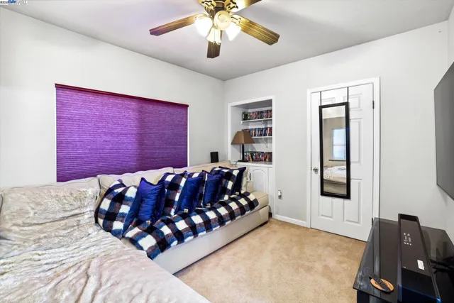 a bed sitting in a bedroom next to a window